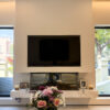 Sleek Media Center Design | Minimalist Plastered Wall & Natural Marble Accent