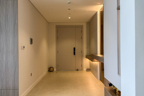 Luxury Apartment Entryway | Minimalist Wood Paneling & Backlit Mirror Console