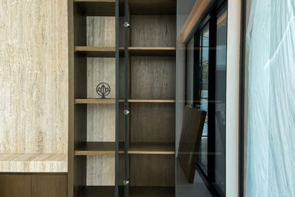 Alternative view of Modern Open-Plan Dining | Travertine Textures & Custom Glass Cabinetry
