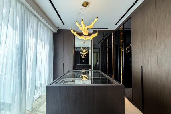 Alternative view of Luxury Walk In Closet Design | Dark Wood Island with Glass Top & Accent Chandelier