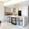 Modern Bright Kitchen Architecture | Glass-Front Island & Pocket Door Pantry